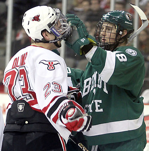 Bemidji State's Radoslav Illo adjusts the facemask of UNO's Eric Olimb during the first period. Illo received a penalty on the play. UNO and Bemidji State skated to a 2-2 tie Friday night at Qwest Center Omaha. (Photo by Michelle Bishop) (Michelle Bishop)