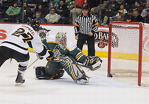 Colorado College's William Rapuzzi scores past Alaska-Anchorage's Chris Kamal in the first period of their WCHA Final Five quarterfinal game Thursday, March 17, 2011. (Tim Brule)