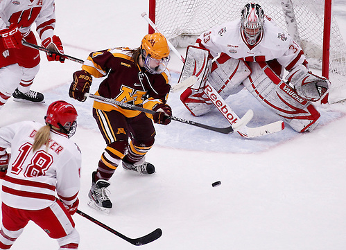 Minnesota's Becky Kortum battles between Wisconsin's Brianna Becker (18) and goalie Alex Rigsby during the first period of an NCAA college hockey game Friday, Jan. 25, 2013, in Madison, Wis. (AP Photo/Andy Manis) (Andy Manis/AP)
