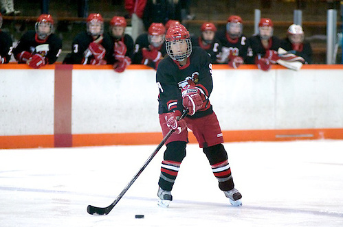 Allison Era of Plattsburgh controls the puck on the power play as her teammates look on from the bench (2012 Omar Phillips)