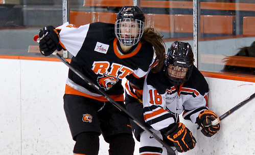 Mackenzie Stone (RIT- 14) and Hilary Lloyd (Princeton - 18) battle along the boards. ((c) Shelley M. Szwast 2013)