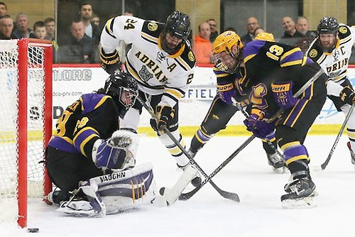 Wisconsin-Stevens Point goaltender Max Milosek makes a save with Adrian's Daniel Lisi and the Pointer's Nathan Harris in front. (Mike Dickie Photography)