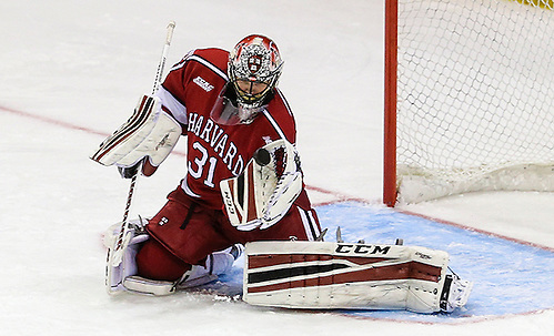 March 19, 2016:  Harvard Crimson goalie Merrick Madsen (31) watches puck as it approaches his glove during 2016 ECAC Tournament Championship game between Harvard University and Quinnipiac University at Herb Brooks Arena in Lake Placid, NY. (John Crouch/J. Alexander Imaging)