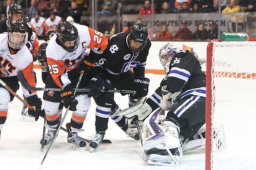 Paul Berrafato (36 - Holy Cross) makes a save in overtime as Josh Mitchell (25 - RIT) looks for a rebound (Omar Phillips)