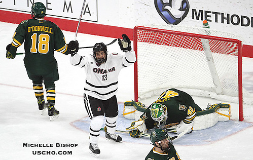 Omaha's Jake Randolph (13) celebrates Luc Snuggerud's goal during the second period. Omaha and Vermont skated to a 4-4 tie Friday night at Baxter Arena.  (Photo by Michelle Bishop) (Michelle Bishop)