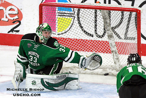 North Dakota goalie Cam Johnson is unable to stop a shot by Omaha's David Pope during the third period. North Dakota beat Omaha 7-3 Saturday night at Baxter Arena. (Photo by Michelle Bishop) (Michelle Bishop)