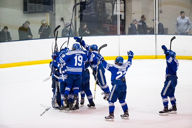 Colby Mules celebrate a win after scoring a second goal with 1.6 second remaining in regulation against the Geneseo Knights at the NCAA Division III men's ice hockey Tournament Second-Round between the Geneseo Knights and the Colby Mules on March 17, 2018. Collby defeats Geneseo 2-1. Photograph by Brett Carlsen for Colby College. (Brett Carlsen)