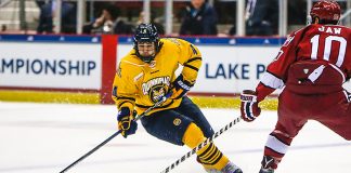 March 19, 2016: Quinnipiac Bobcats defenseman Connor Clifton (4) skates with the puck as Harvard Crimson forward Brayden Jaw (10) tries to defend during 2016 ECAC Tournament Championship game between Harvard University and Quinnipiac University at Herb Brooks Arena in Lake Placid, NY. (John Crouch/J. Alexander Imaging)