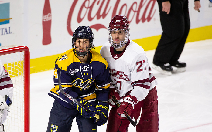 AMHERST, MA - NOVEMBER 22: Jake McLaughlin #27 of the Massachusetts Minutemen and Tyler Drevitch #4 of the Merrimack College Warriors during NCAA men's hockey at the Mullins Center on November 22, 2019 in Amherst, Massachusetts. The game ended in a 2-2 tie. (Photo by Rich Gagnon/USCHO) (Rich Gagnon)